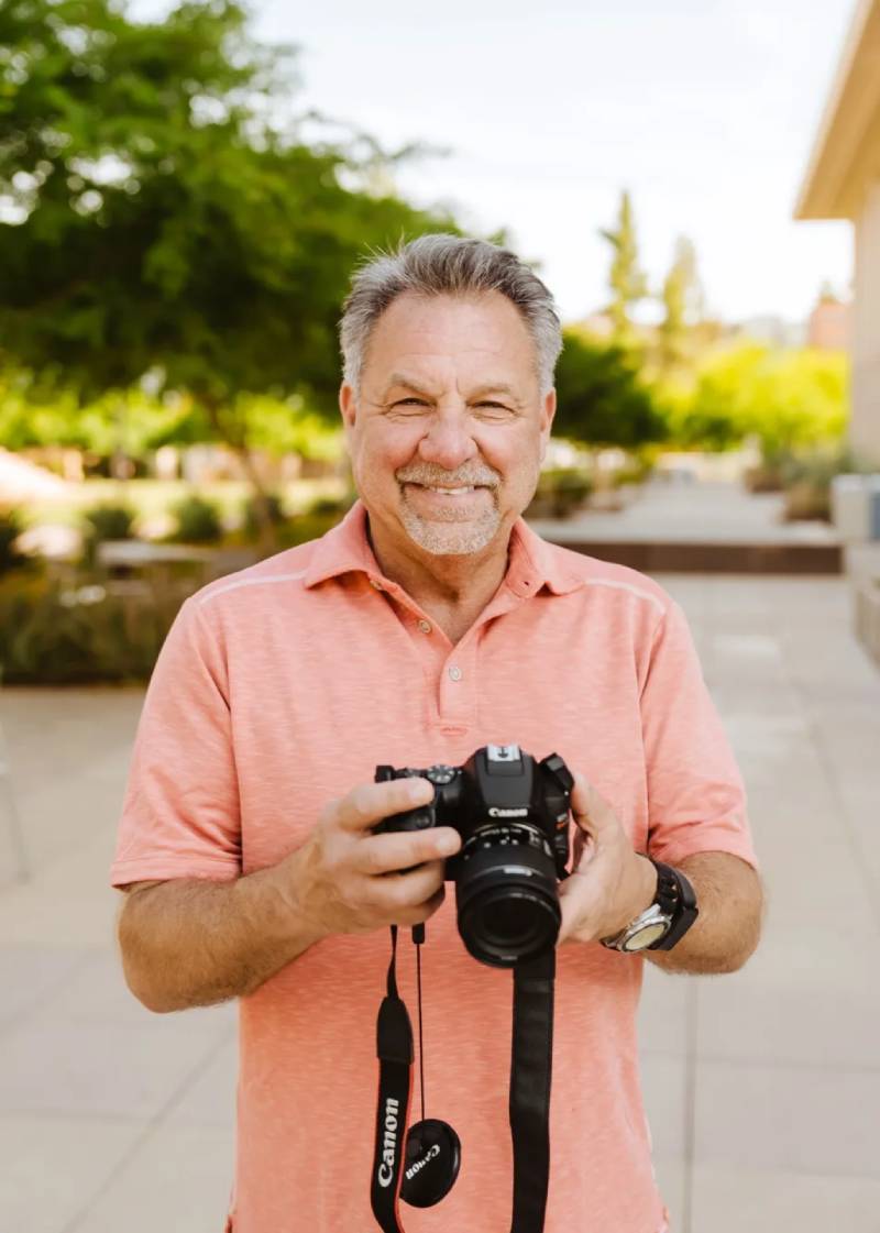 A man holding a camera in his hands.
