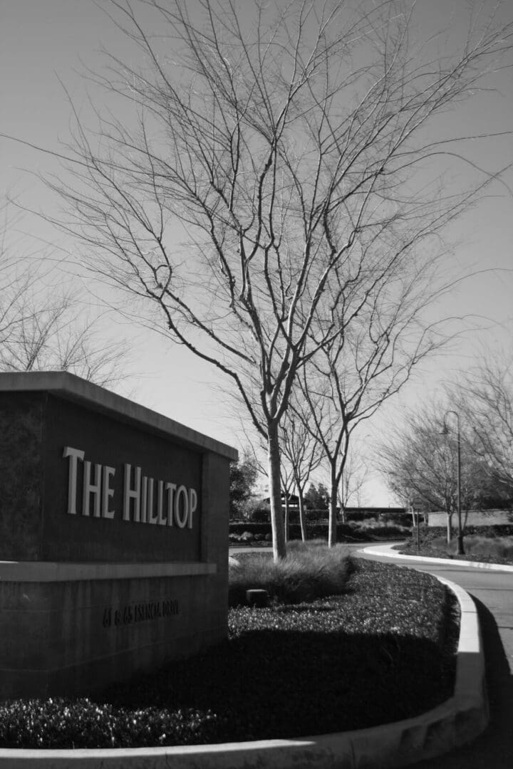 A black and white photo of the entrance to the hilltop.